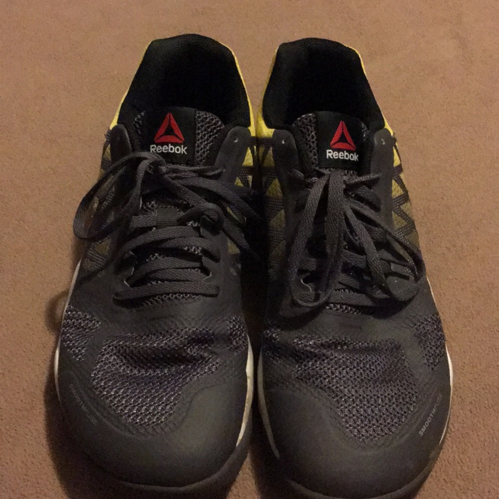 Men’s gray and yellow Reebok tennis shoes